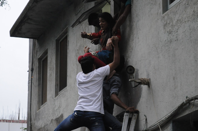 Nazea Sayed being taken out of the window